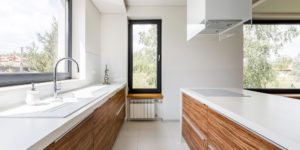 modern white and wood-accented kitchen in open-plan home