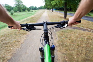 Bicycle rider riding on dirt bike path, motion blur