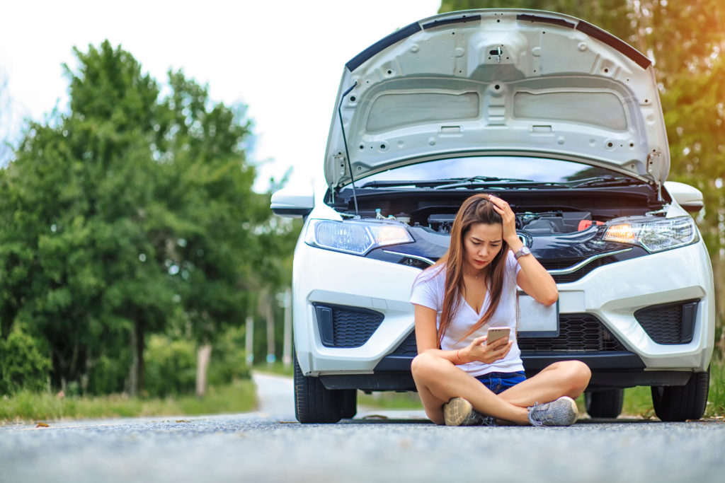 Stressed,Young,Woman,Frustrated,Woman,Sitting,After,A,Car,Breakdown